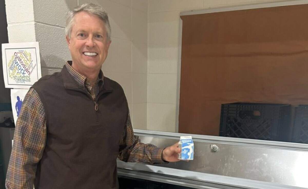 Sen. Roger Marshall holds a box of milk during a visit to a Garden City elementary school.